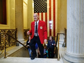 Red-jacketed tour leaders, furloughed during the 16-day U.S. government shutdown, lead tours in the U.S. Capitol Rotunda in Washington, October 17, 2013.  (REUTERS/Jonathan Ernst)