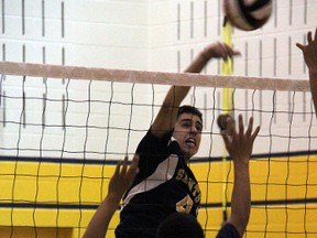 Saints player Nethanial Gabrial spikes over the net vs. Montcalm during TVRA Central Tier II volleyball action at SDCI Oct. 17. Despite dropping their sixth straight contest to open the year, Strathroy is keeping a positive attitude regarding their 2013 campaign.
JACOB ROBINSON/AGE DISPATCH/QMI AGENCY