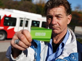 Gary Kerr holds the Presto card he says hasn't worked for a week while standing at the Dominion Transitway station Friday, Oct. 18, 2013. Darren Brown/Ottawa Sun