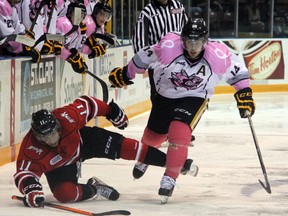 Sarnia Sting forward Nick Latta shoves off Owen Sound Attack forward Cameron Brace during the second period of the Attack's 4-2 win on Friday night. Latta would end up taking a holding penalty on the play. (SHAUN BISSON, The Observer)