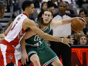 Raptors' Austin Daye (left) and Celtics' Kelly Olynyk mix it up during pre-season action. (Craig Robertson/Toronto Sun)