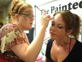 Sarnia makeup artist Cat Cabajar paints a flower on Sky Blommaert, 19, of Sarnia, at a body art and henna workshop. BARBARA SIMPSON / THE OBSERVER / QMI AGENCY