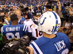 Denver Broncos quarterback Peyton Manning (18) shakes hands with Indianapolis Colts quarterback Andrew Luck (12) after the game at Lucas Oil Stadium, Sunday, Oct 20, 2013. (Brian Spurlock/USA TODAY Sports)
