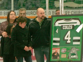 Michelle Coles looks at the Drayton Valley Thunder jersey that will be hung in remembrance for Roger Coles, a huge supporter of the team who died in June. The Thunder held a special celebration of Roger prior to defeating the Canmore Eagles on Oct. 18.