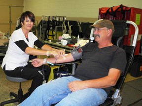Carmen Hall, a phlebotomist with Canadian Blood Services, attends to donor H. Oliver Hoffmeyer, of Mitchell, during a blood donor clinic at the Mitchell Arena last Friday, Oct. 18. It was Hoffmeyers 47th time giving blood. KRISTINE JEAN/MITCHELL ADVOCATE