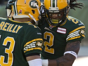 Quarterback Mike Reilly and receiver Fred Stamps celebrate a touchdown at Commonwealth Stadium last month.