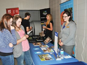 From leftt: Hilltop students Samantha Soper, 14 and Rebecca Hibbs talk to Trinity Western University from Langley, B.C. during a career fair at Hilltop High School on Thursday, Oct. 17.
Barry Kerton | Whitecourt Star