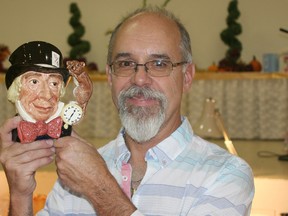 Dave Simpson of Treasures of the Past antique shop in Harrow poses with a Royal Doulton Mad Hatter character mug from the late 1960s or early 1970s. Simpson was one of about 20 exhibitors at the annual antique show and sale held at the Chatham Banquet and Conference Centre on Merritt Avenue on Oct. 19 and 20. The event was jointly sponsored by the Kent Regiment Chapter IODE and Victoria Avenue United Church.
