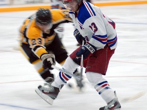 Radar Brenden Dale goes in for the shot as Milverton’s Mark Hamilton tries to knock the puck loose.