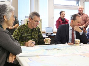Maj.-Gen. Jim Ferron sits down with military and federal government staff for a briefing Tuesday morning during an exercise at CFB Kingston. (Elliot Ferguson The Whig-Standard)