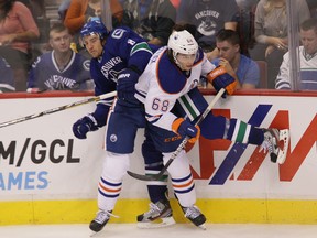 Tyler Pitlick showed an ability to bang the body during this preseason game against the Canucks. He's hoping that trait will help him stick with the Oilers longterm. (QMI Agency)