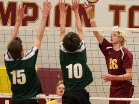 Regiopolis-Notre Dame Panthers’ Greg Borschneck (16) tries to hit the ball past Holy Cross Crusaders Ryan Kinsella (15) and Chris Kimmerer (10) in Kingston Area Secondary Schools Athletic Association senior boys volleyball action at Regiopolis-Notre Dame on Tuesday. The Panthers won the match 3-1. (Ian MacAlpine/The Whig-Standard)