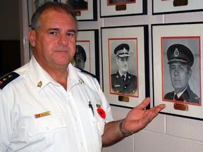 St. Thomas Police Insp. Mark Traichevich stands next to a photo of former St. Thomas chief Carl Johnson on Tuesday. Johnson died Sunday at the age of 82. He was chief of the St. Thomas Police Service from 1984-87.