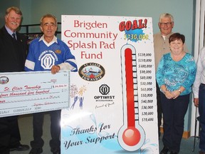 St. Clair Mayor Steve Arnold, left, accepts a cheque for just under $55,000 from representatives of the Brigden Optimists - Mike Courtney, Ray Carroll, Mary Thompson, and Joe Thompson - at a recent council meeting in the township. The funds represent the club's share of the building of a splash pad in the community last summer. HEATHER YOUNG/ SARNIA THIS WEEK/ QMI AGENCY