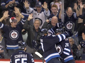 Winnipeg Jets right winger Blake Wheeler (right) and teammates Mark Scheifele (left) and  left winger Evander Kane celebrate Wheeler's second period goal against the Washington Capitals during NHL hockey in Winnipeg, Man. Tuesday, October 22, 2013.  Mark Scheifele and Kane assisted on the goal.(BRIAN DONOGH/WINNIPEG SUN/QMI AGENCY)