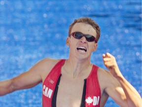 Simon Whitfield crosses the finish line to claim the gold medal in the triathlon at the Sydney Summer Olympics in 2000.
File photo
