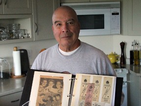 Barry Howson poses with a scrap book of his awards, as well as trophies for his induction to the Ontario Basketball Hall of Fame (left), Canadian Basketball Hall of Fame (right) and a ball autographed by the members of the St. Patrick's Fighting Irish senior boys basketball team Howson coached to an OFSAA 'A' title in 2013. On Nov. 7, 2013, Howson will be inducted into the London Sports Hall of Fame. SHAUN BISSON/THE OBSERVER/QMI AGENCY