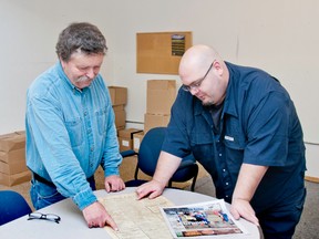 Farley Wuth (left), curator of the Kootenai Brown Pioneer Museum points out how newspaper design has changed with current Echo editor Bryan Passifiume. Jennifer Pinkerton photo.