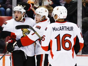 Ottawa Senators right wing Bobby Ryan (left) receives congratulations from center Kyle Turris (7) and left wing Clarke MacArthur (16) after scoring in the first period against the Detroit Red Wings at Joe Louis Arena. Rick Osentoski-USA TODAY Sports