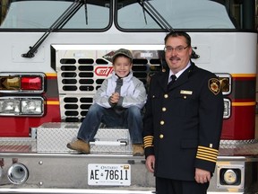 Freddy Pawson, 6, with Fire Chief Richard Vallee, getting ready for his ride to school in the fire truck.