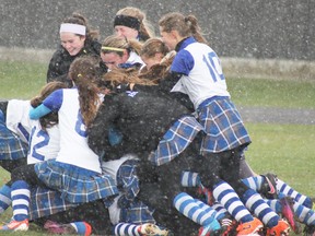 Goderich Vikings celebrate in heavy rain after edging South Huron Panthers 2-1 in the WOSSAA field hockey final at GDCI Thursday.