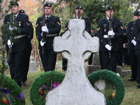 A Canadian Forces honour guard stands in front of the grave of Maj. Bruce Carruthers, considered the founder of the Canadian signal corps, during a ceremony Thursday morning at the Cataraqui Cemetery. 
Elliot Ferguson The Whig-Standard