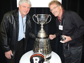 Jim Piaskoski and Gerry Organ reunite with the Grey Cup at a Kiwanis luncheon Friday at the Ottawa Conference and Event Centre. TIM BAINES/OTTAWA SUN