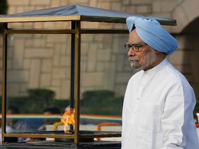 India's Prime Minister Manmohan Singh walks after paying homage at the Mahatma Gandhi memorial, on the 144th birth anniversary of Gandhi in New Delhi. 
REUTERS/Adnan Abidi