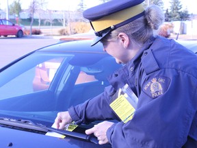 Above: Cst. Shelley Nasheim assesses parked cars for locked doors and valuables as part of an anti-theft awareness campaign in Spruce Grove on Oct. 18. RCMP officers will leave tips and information for motorists throughout Spruce Grove’s high theft areas.
Below: The brochure material RCMP will leave on neighbourhood car windshields in the coming weeks. - Karen Haynes, Reporter/Examiner