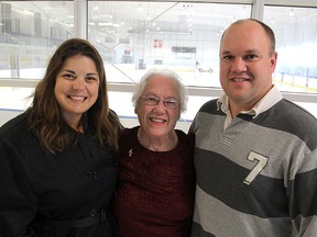 Reta Thompson, centre, flanked by her nephew Derek Thompson and his wife Amy, is receiving a special jersey from a girls hockey team on Sunday to mark her beating breast cancer. 
Michael Lea The Whig-Standard