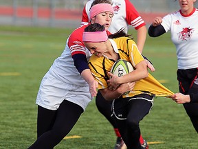 Bayside's Amanda Blair tackles a Trenton ballcarrier during Bay of Quinte senior girls rugby final, Friday, at MAS Park Field 2. (TIM MEEKS/The Intelligencer)