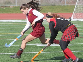 Regiopolis-Notre Dame’s Jasmine Zahra, left, and Sydenham’s Kaili Warmingtom keep pace with the rolling ball during the Kingston Area girls field hockey championship game at CaraCo Home Field Friday afternoon. Regi won 3-0. (Michael Lea/The Whig-Standard)