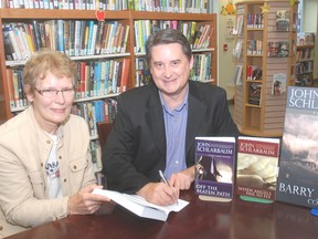 Kathy Johnston of West Lorne had author John Schlarbaum sign her book when he visited the West Lorne library last week as part of Ontario Public Libraries Week.