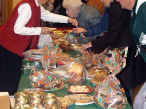 People look over the edible goods for sale at Knox United’s Christmas Tea and Bazaar on Saturday, Oct. 26.