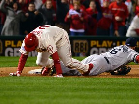 St. Louis Cardinals' Allen Craig trips over Will Middlebrooks of the Boston Red Sox, resulting in the winning run in Game 3 of the World Series. (Scott Rovak, USA Today Sports)
