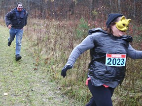 Zombie Wil Crain chases a runner in the Canadian Cancer Society’s inaugural Dash of the Living Dead on Saturday at the Westbrook Multisport Complex. (Elliot Ferguson The Whig-Standard)