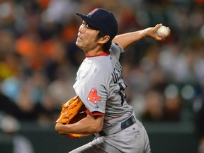 Boston Red Sox relief pitcher Koji Uehara works against the Baltimore Orioles during the ninth inning of  their MLB American League baseball game in Baltimore, Maryland September 27, 2013. (REUTERS/Doug Kapustin)