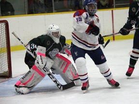 Strathroy Rockets forward Ryan Field screens St. Mary’s Lincolns goalie Quentin Prokopetz during an 8-1 win Sunday at the West Middlesex Memorial Centre. The Rockets snapped a three game losing streak with the victory.
JACOB ROBINSON/AGE DISPATCH/QMI AGENCY