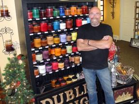 Art Larivee stands beside a popular candle display at his Dublin Design Inc. business. KRISTINE JEAN/MITCHELL ADVOCATE