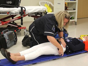 Frontenac paramedics Andrea Baker and Jeremie Hurtubise demonstrate how they would treat an accident victim, using student Samantha Mahoney as their subject.
Michael Lea The Whig-Standard