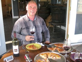 Dave Bergeron of Bergeron Estate Winery with some of the wine and pizza offered at the establishment. (Greg Burliuk The Whig-Standard)