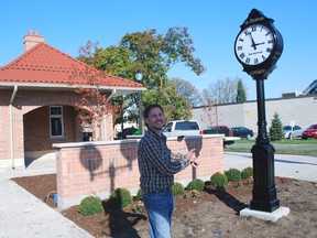 St. Thomas Downtown Development Board chairman Dan Muscat points toward a new 11-foot-tall cast aluminum clock installed Wednesday outside the new city tourism office on Talbot St. The DDB paid for the clock, which cost about $15,000 and has an estimated life expectancy of 100 years.