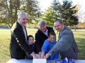 A $5,000 donation was made by Union Gas at the Lorne C. Henderson Conservation Area for a program that will teach students about safety around watercourses during the winter and spring. From left to right: Chris Young Administration Manager, STO, Union Gas Limited; Kerian  Moorey  grade 3, High Park Public School, Sarnia; Steve Arnold, Chair, St. Clair Region Conservation Authority; Owen Evoy, grade 3, High Park Public School, Sarnia; Dave Lamoureux, director of storage and transmission operations for Union Gas. They all have their hands in ice water to get an idea of how cold and shocking it would be should you fall through the ice.
SUBMITTED PHOTO