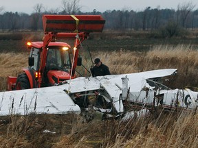 Two Ottawa men died Wednesday when the small plane they were flying in crashed near the Ottawa airport. William Barry Stratton and Jacques Domey were on the last leg of a return trip from Florida when the crash happened Wednesday. Investigators were on the scene with Police in Ottawa December 14, 2011. Transportation Safety Board and salvage workers move the plane Thursday.  Tony Caldwell/Ottawa Sun/QMI Agency