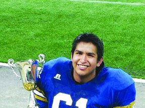 Long Plain First Nation's Shaden Meeches poses with the Manitoba Major Football League Championship that he won with the Fort Garry Lions last week.