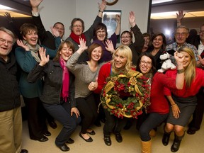 Auction producer and former Sun publisher David Black, far left, celebrates with volunteers and organizers at the conclusion of the 10th annual ATCO Sun Christmas Charity Auction at the Christmas Bureau’s office on Thursday. The auction raised over $200,000 for the Christmas Bureau, the United Way Alberta Capital Region, the Stollery Children’s Hospital Foundation and Catholic Social Services Sign of Hope! campaign. (IAN KUCERAK/EDMONTON SUN)