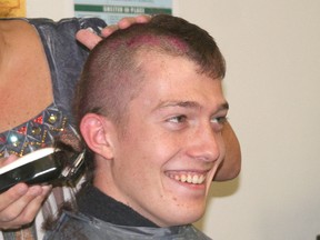 McGregor student council president Josh Reding gets his head shaved for charity.