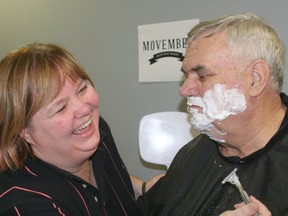 Mary Brown laughs as she shaves her husband Wayne Eltervoog for the kickoff event of the Chatham Mazda Movember team. For Eltervoog, it was the first time in more than 40 years that he's been clean-shaven.