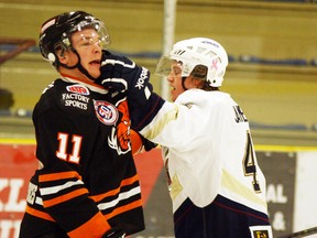 Connor James of the Saints (right) illustrates a point — with his knuckles — to Lloydminster’s Braden Crone just moments after the Saints had scored to take a 2-1 lead in a game they eventually won in a shootout after a 2-2 regulation time tie. - Gord Montgomery, Reporter/Examiner