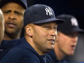 New York Yankees Derek Jeter watches play from the dugout during the seventh inning of their American League MLB baseball game against the Toronto Blue Jays in Toronto September 18, 2013.  (REUTERS)